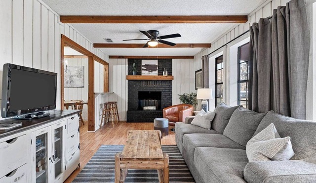 Unwind in a cozy rustic-modern cabin with a front porch, private dock access, firepit nights, outdoor dining, and cornhole. RV site next to house. in Karnack